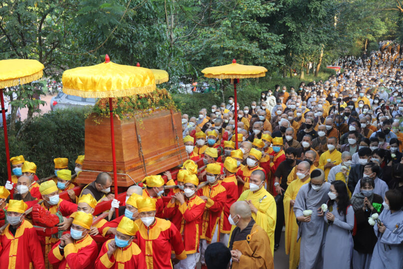 Coffin of Vietnamese Buddhist monk Thích Nhất Hạnh is carried to the street during his funeral in Hue, Vietnam Saturday, Jan. 29, 2022. A funeral was held Saturday for Thich Nhat Hanh, a week after the renowned Zen master died at the age of 95 in Hue in central Vietnam. (AP Photo/Thanh Vo)