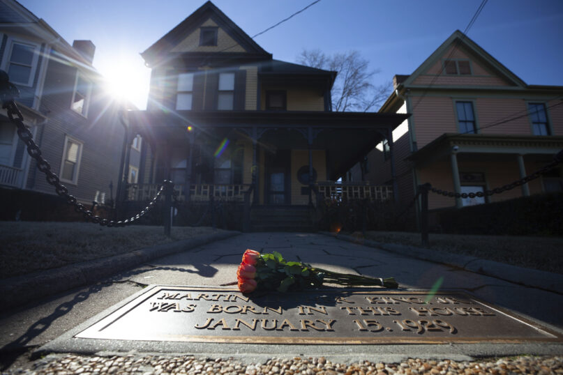 FILE - Flowers lay in front of the birthplace of Dr. Martin Luther King, Jr., on Jan. 18, 2021, in Atlanta. The annual Martin Luther King Jr. service is set to be held at his old congregation in Atlanta. (AP Photo/Branden Camp, File)