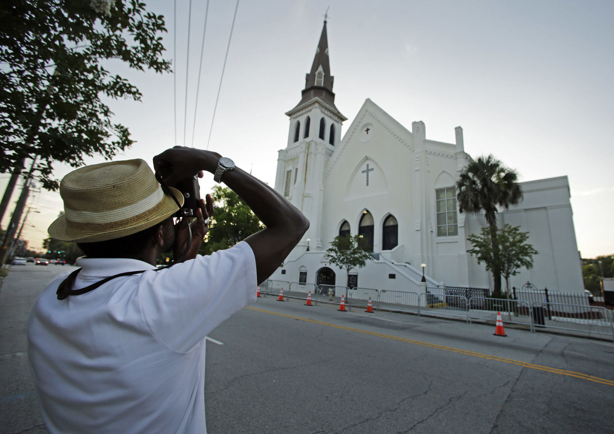 FILE _ This file photo shows Ausar Vandross taking a photo of Mother Emanuel AME Church in Charleston, S.C., on Thursday, June 16, 2016. The church is among those that have been assisted by a fund to help historic Black churches, and a new, $20 million donation will help additional ones. (AP Photo/Chuck Burton)