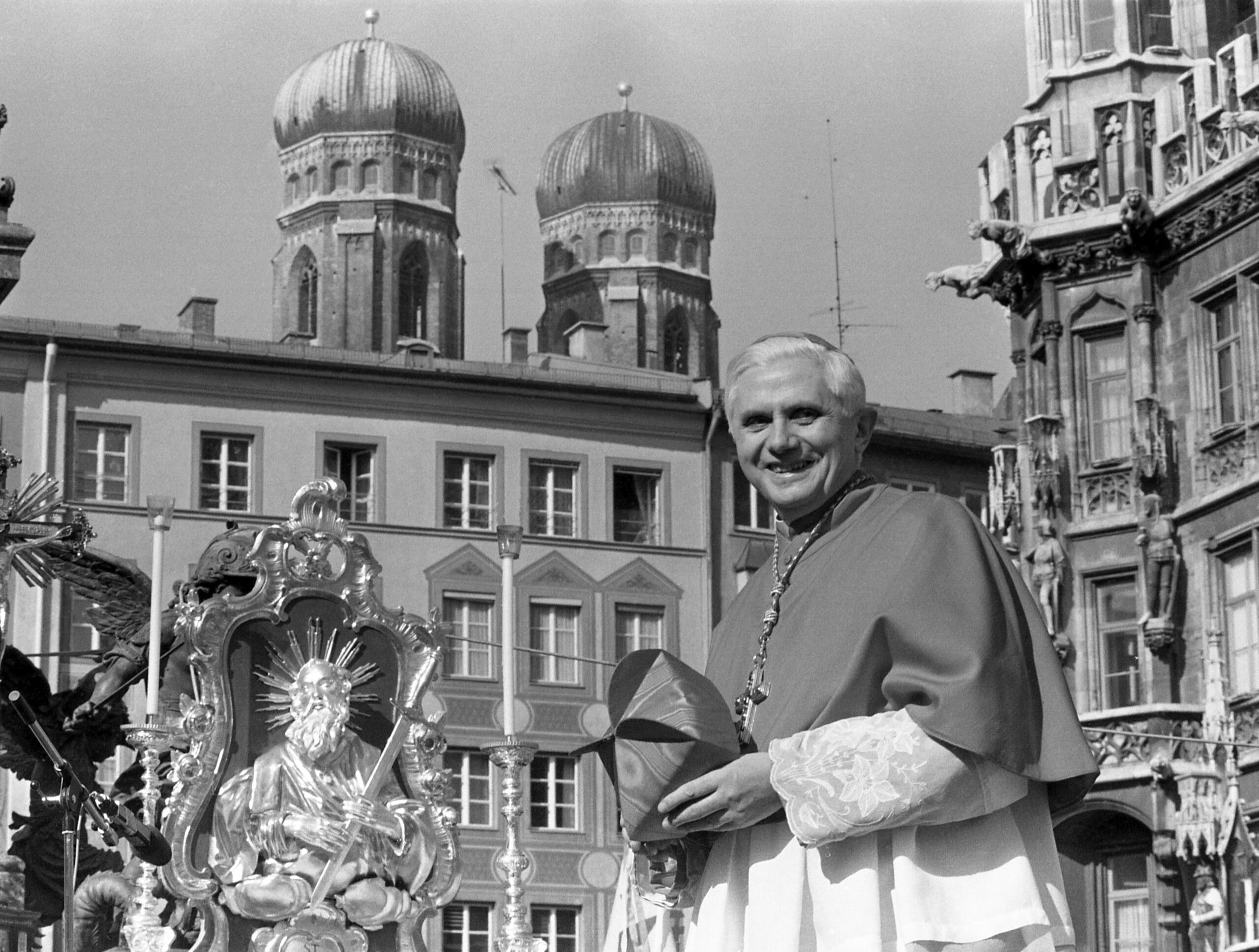 With the towers of the cathedral in the background, Cardinal Joseph Ratzinger, later Pope Benedict XVI, bids farewell to the Bavarian believers in downtown Munich, Germany, Feb. 28, 1982. The Vatican on Jan. 26, 2022, strongly defended Pope Emeritus Benedict XVI’s record in fighting clergy sexual abuse and cautioned against looking for “easy scapegoats and summary judgments,” after an independent report faulted his handling of four cases of abuse when he was archbishop of Munich. (AP Photo/Dieter Endlicher, File)