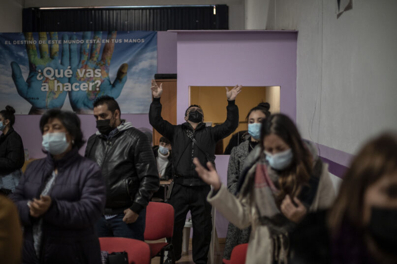 A man from Venezuela prays with other Latin-American parishioners during a Sunday Mass at the Pentecostal church of Salamanca, Spain, on Sunday, Dec. 5, 2021. The steady growth of the Protestant population coincides with a steady drop in the number of churchgoing Catholics. (AP Photo/Manu Brabo)