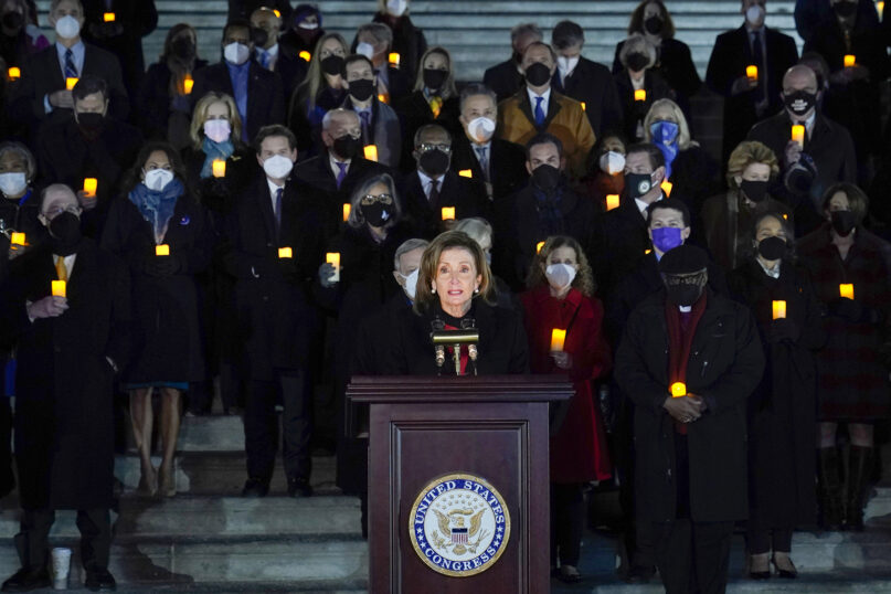 House Speaker Nancy Pelosi of California, standing with members of the House and Senate, speaks during a prayer vigil on the east steps of Capitol Hill in Washington, Jan. 6, 2022, to mark the one-year anniversary of the Jan. 6 attack on the Capitol by supporters loyal to then-President Donald Trump. (AP Photo/Susan Walsh)