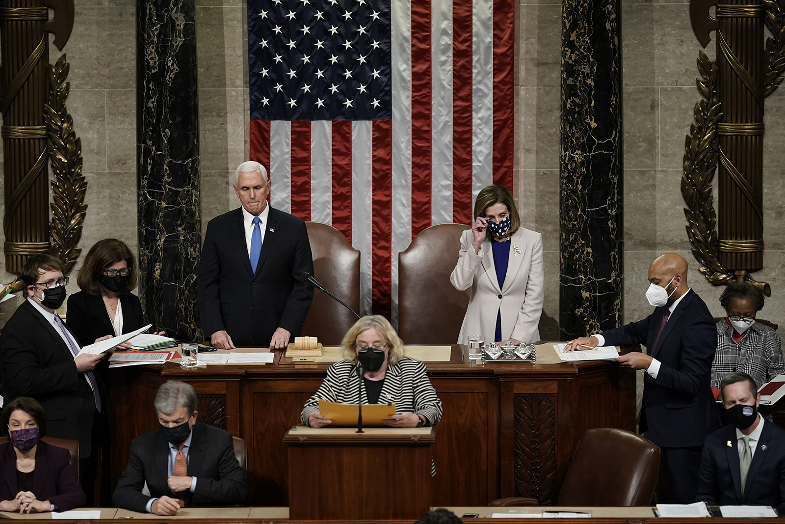 Vice President Mike Pence, left, and Speaker of the House Nancy Pelosi, D-Calif., right, read the final certification of Electoral College votes cast in November's presidential election during a joint session of Congress after working through the night, at the Capitol in Washington, Jan. 7, 2021. (AP Photo/J. Scott Applewhite, Pool)