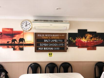 The Halal restuarant in London has a variety of daily specials that are marked on a chalkboard in the dining room. Early in the pandemic, Mehnaz Mahaboob tweeted a photo of his family's Indian restaurant asking people to try out their food. RNS photo by Joseph Hammond