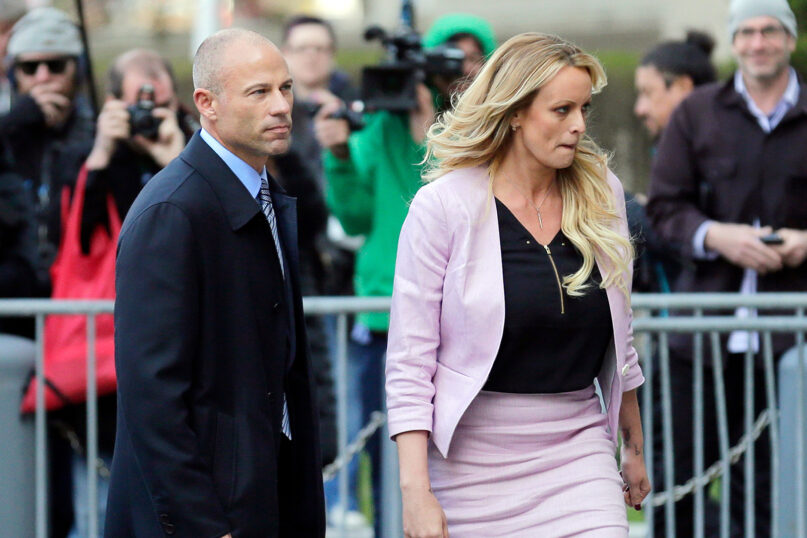 FILE- Adult film actress Stormy Daniels, right, accompanied by her attorney, Michael Avenatti, left, walk away after speaking to the media outside federal court, on April 16, 2018, in New York. Avenatti, the once high-profile California attorney who regularly taunted then-President Donald Trump during frequent television appearances, was introduced Thursday, Jan. 20, 2022, to prospective jurors who will decide whether he cheated porn star Stormy Daniels out of book-deal proceeds. (AP Photo/Seth Wenig, File)
