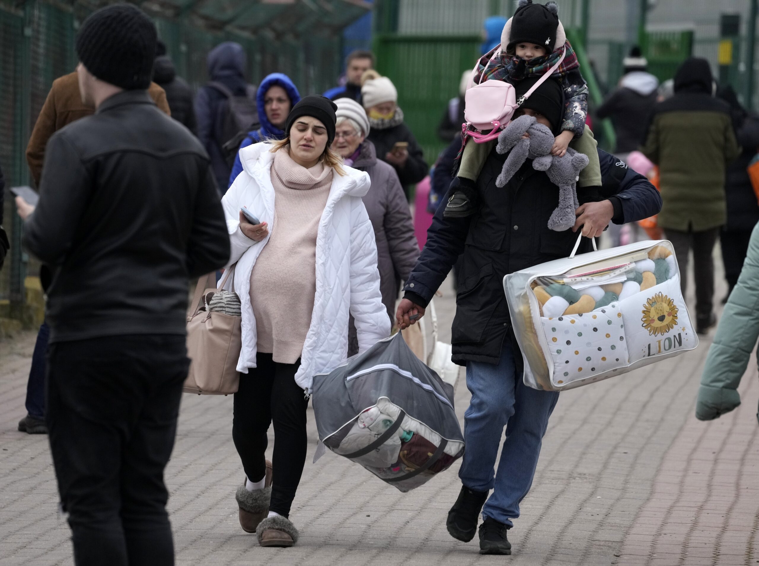 People fleeing the conflict from neighboring Ukraine, arrive at the border crossing in Medyka, southeastern Poland, on Friday, Feb. 25, 2022. U.N. officials said that 100,000 people were believed to have left their homes and estimated up to 4 million could flee if the fighting escalates.(AP Photo/Czarek Sokolowski)