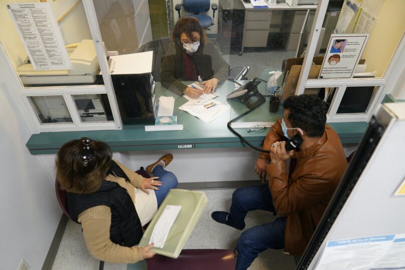 Mohammad Attaie and his wife, Deena, newly arrived from Afghanistan, get assistance from medical translator Jahannaz Afshar at the Valley Health Center TB/Refugee Program in San Jose, Calif., on Dec. 9, 2021.  (AP Photo/Eric Risberg)