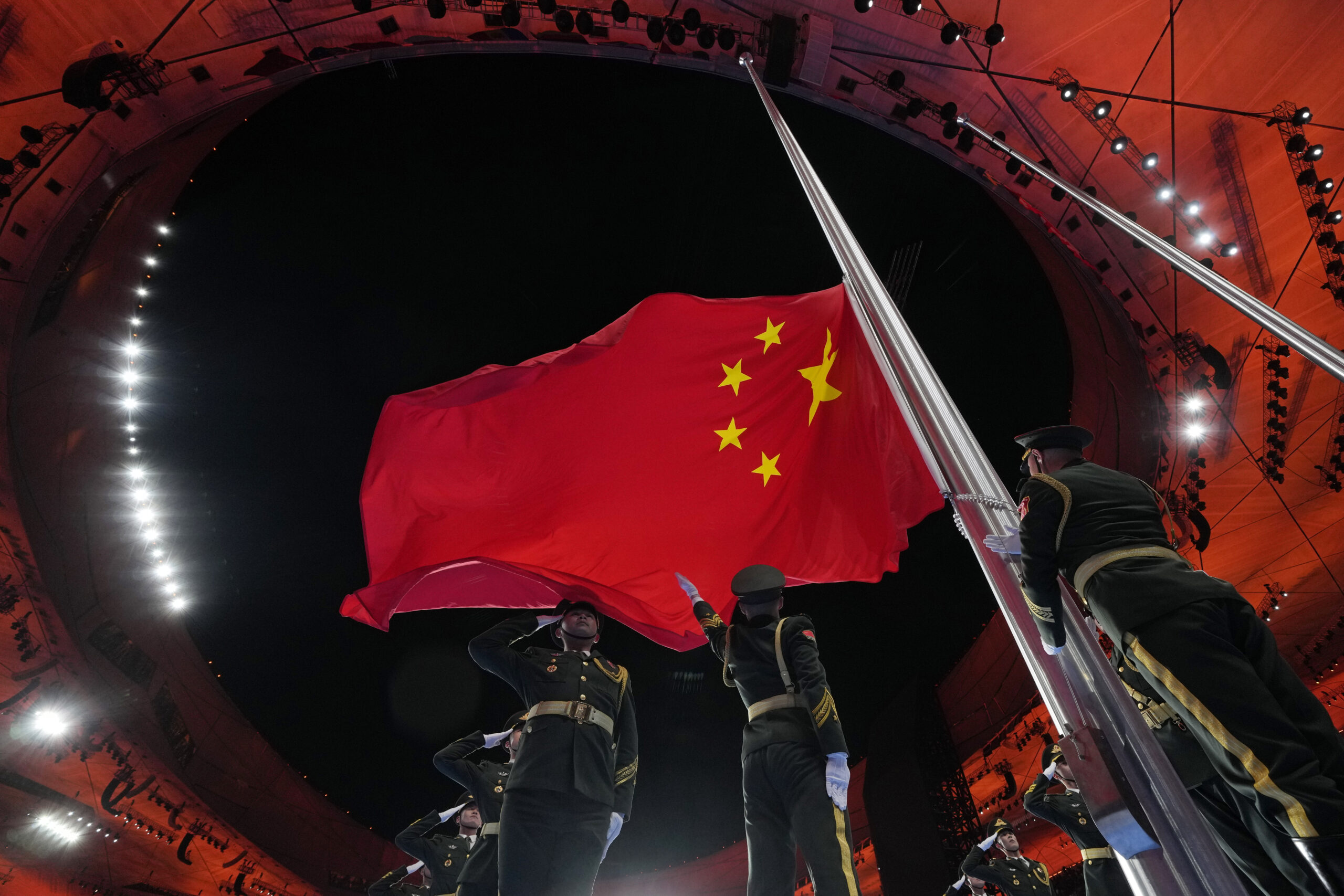 The Chinese national flag is raised during the opening ceremony of the 2022 Winter Olympics, Friday, Feb. 4, 2022, in Beijing. (AP Photo/Natacha Pisarenko)