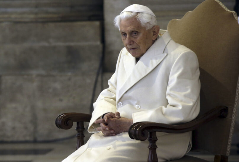 FILE - This Dec. 8, 2015 file photo shows Pope Emeritus Benedict XVI in St. Peter's Basilica as he attends the ceremony marking the start of the Holy Year. (AP Photo/Gregorio Borgia)