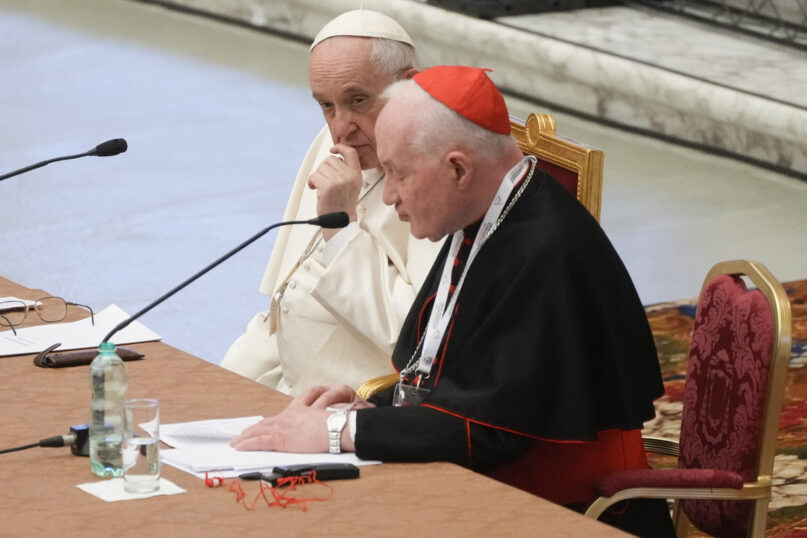 Pope Francis, left, listens to Cardinal Marc Ouellet's opening address at the three-day Symposium on Vocations in the Paul VI Hall at the Vatican, Feb. 17, 2022. (AP Photo/Gregorio Borgia)