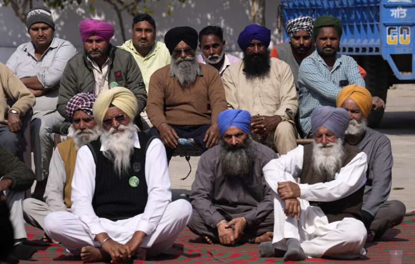 A group of village elders listen to the speech of one of the candidate contesting for the state assembly elections in village Derra Bassi, in Indian state of Punjab, Monday, Feb. 14, 2022. India's Punjab state will cast ballots on Sunday, in polls that are seen as a barometer of Prime Minister Narendra Modi's popularity ahead of general elections in 2024 and his party's Hindu nationalist reach. (AP Photo/Manish Swarup)