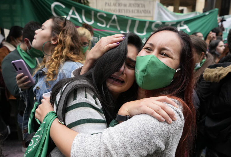 Abortion-rights activists celebrate after the Constitutional Court approved the decriminalization of abortion, lifting all limitations on the procedure until the 24th week of pregnancy, in Bogota, Colombia, Monday, Feb. 21, 2022. (AP Photo/Fernando Vergara)
