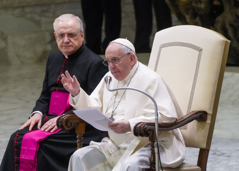 Pope Francis speaks during his weekly general audience in the Paul VI Hall at the Vatican, Wednesday, Feb. 23, 2022. At left Monsignor Leonardo Sapienza. (AP Photo/Gregorio Borgia)
