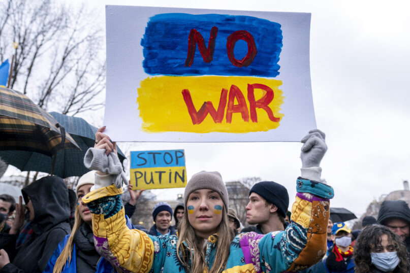 FILE - Ukrainian Oleksandra Yashan holds a sign in Lafayette Park in front of the White House in Washington, Thursday, Feb. 24, 2022, that reads 
