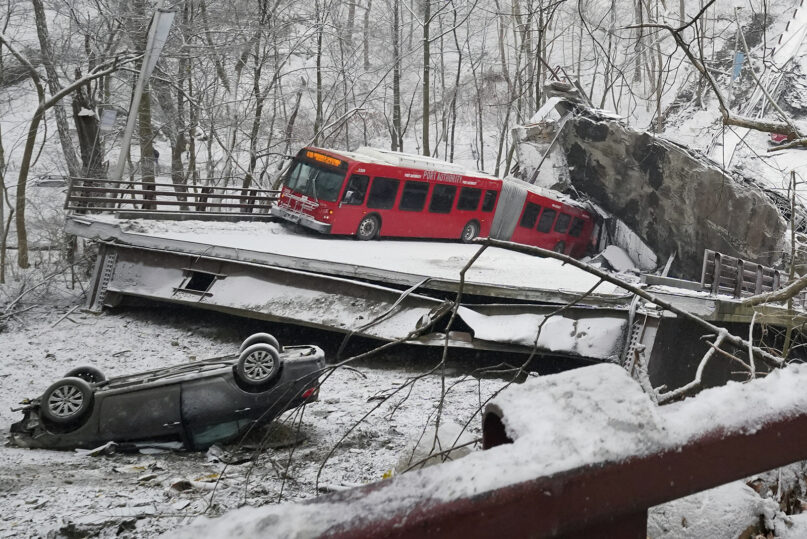 A Port Authority bus and a car that were on a bridge when it collapsed Friday Jan. 28, 2022, are visible in Pittsburgh's East End. When the bridge collapsed, rescuers rappeled nearly 150 feet while others formed a human chain to help rescue multiple people from the dangling bus. (AP Photo/Gene J. Puskar)