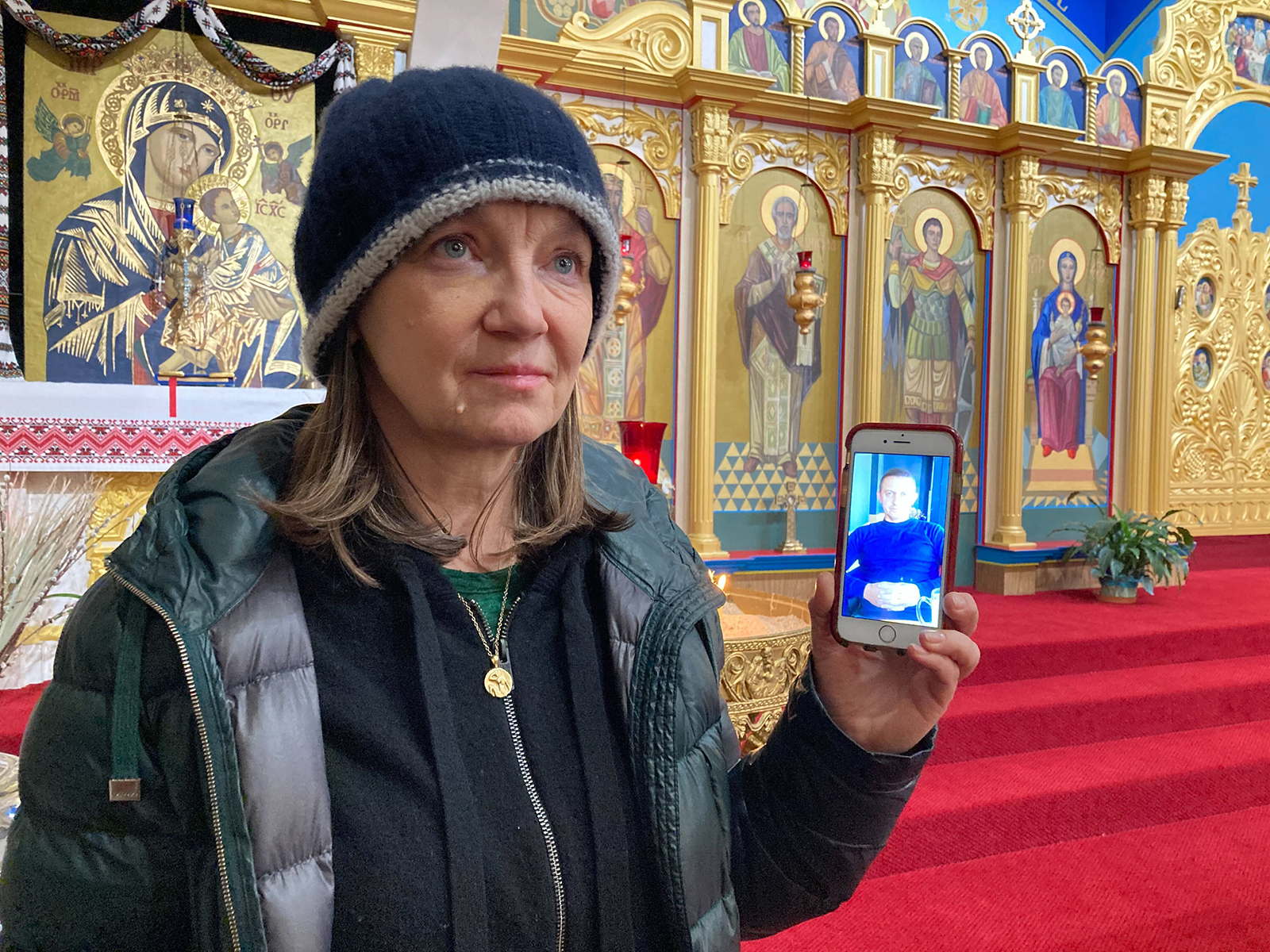 Zoryana Volos speaks at Nativity of the Blessed Virgin Mary, a Ukrainian Catholic Church, Thursday, Feb. 24, 2022, in Los Angeles. Volos said she's worried about her sister’s sons in Ukraine. Here she shows a photo of one of her nephews. RNS photo by Alejandra Molina