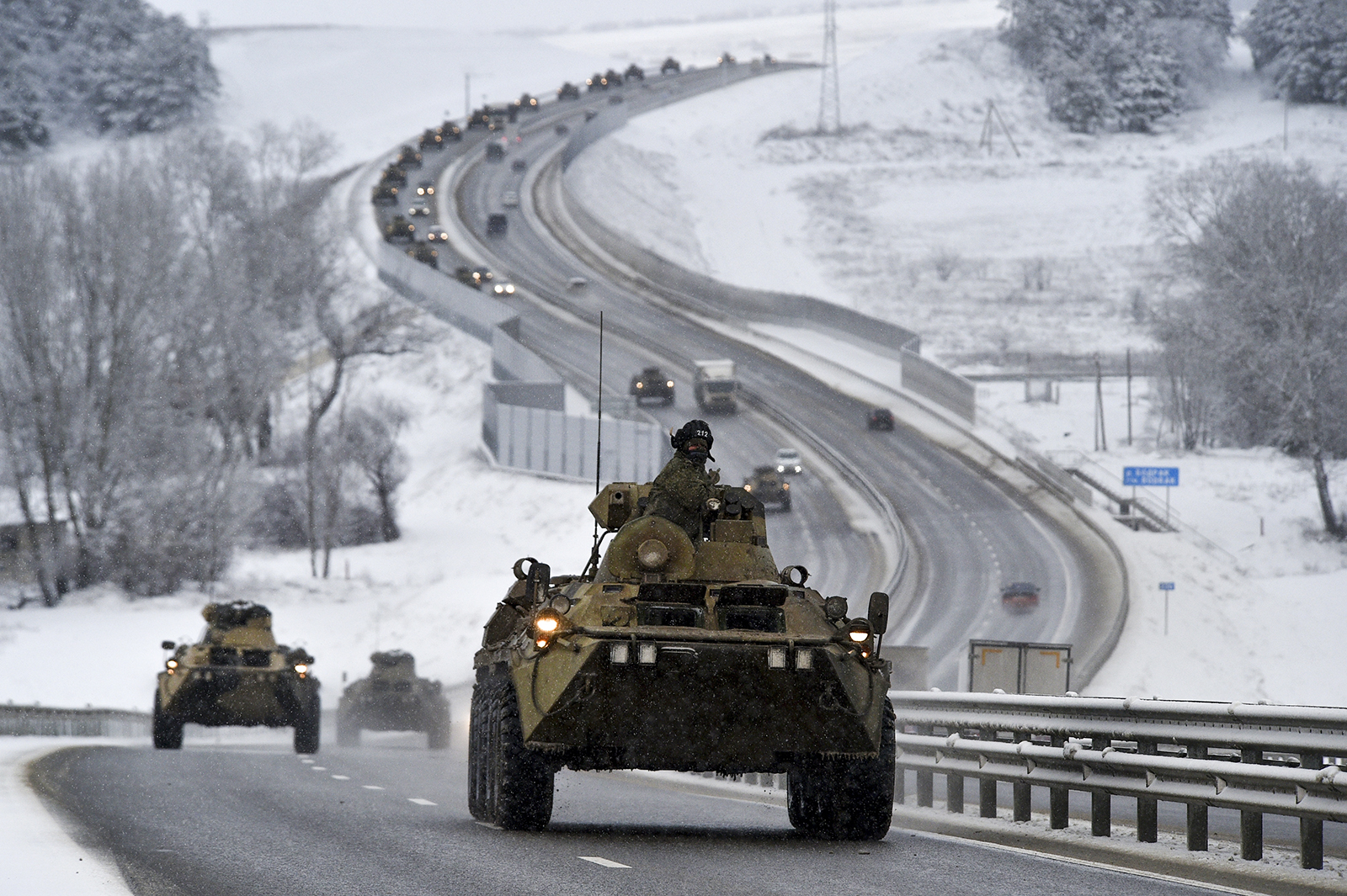 A convoy of Russian armored vehicles moves along a highway in Crimea, Tuesday, Jan. 18, 2022. Russia has concentrated more than 100,000 troops with tanks and other heavy weapons near Ukraine in what the West fears could be a prelude to an invasion. (AP Photo)