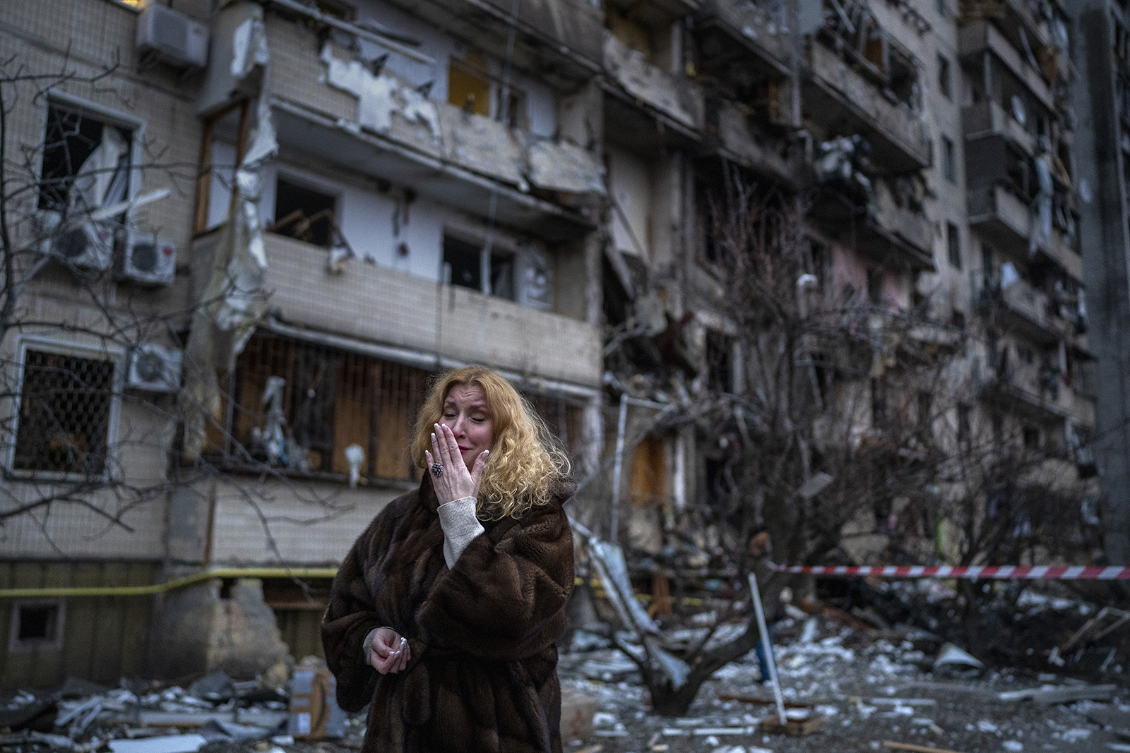 Natali Sevriukova reacts to seeing her residence following a rocket attack in Kyiv, Ukraine, Friday, Feb. 25, 2022. (AP Photo/Emilio Morenatti)