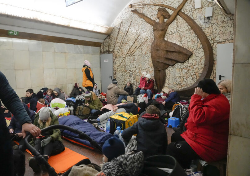 People gather in the Kyiv subway, using it as a bomb shelter, in Kyiv, Ukraine, Friday, Feb. 25, 2022. Russia is pressing its invasion of Ukraine to the outskirts of the capital after unleashing airstrikes on cities and military bases and sending in troops and tanks from three sides. (AP Photo/Efrem Lukatsky)
