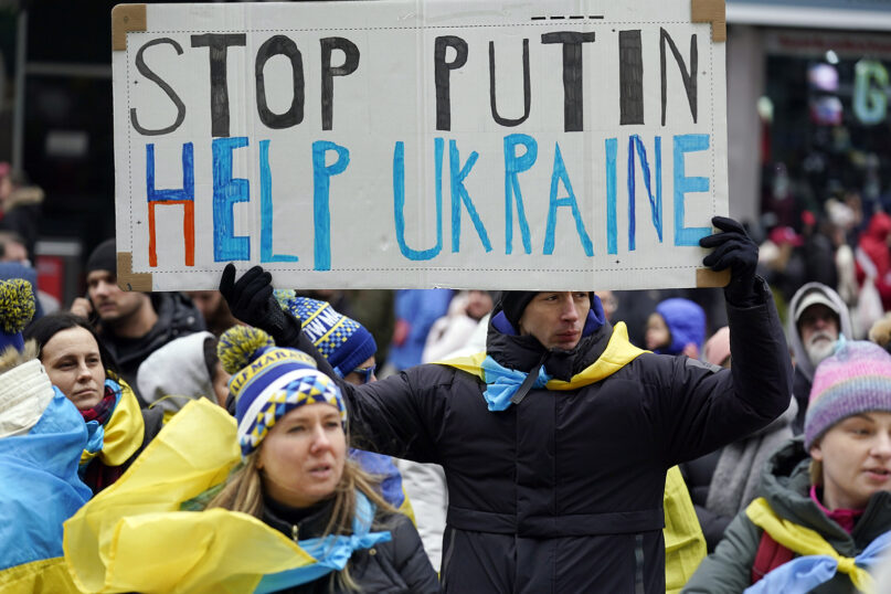 Pro-Ukraine demonstrators carry signs and Ukraine flags in New York's Times Square, Feb. 24, 2022. World leaders condemned Russia's invasion of Ukraine as 