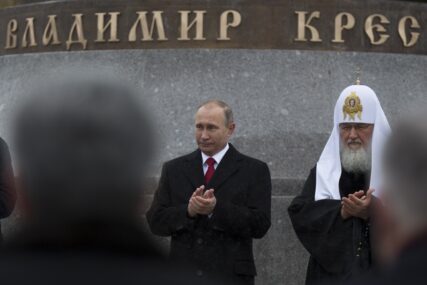FILE - Russian President Vladimir Putin, center, and Russian Orthodox Patriarch Kirill applaud during the unveiling ceremony of a monument to Vladimir the Great on the National Unity Day outside the Kremlin in Moscow, Russia, Friday, Nov. 4, 2016. President Vladimir Putin has led ceremonies launching a large statue outside the Kremlin to a 10th-century prince of Kiev who is credited with making Orthodox Christianity the official faith of Russia, Ukraine and Belarus. (AP Photo/Alexander Zemlianichenko)