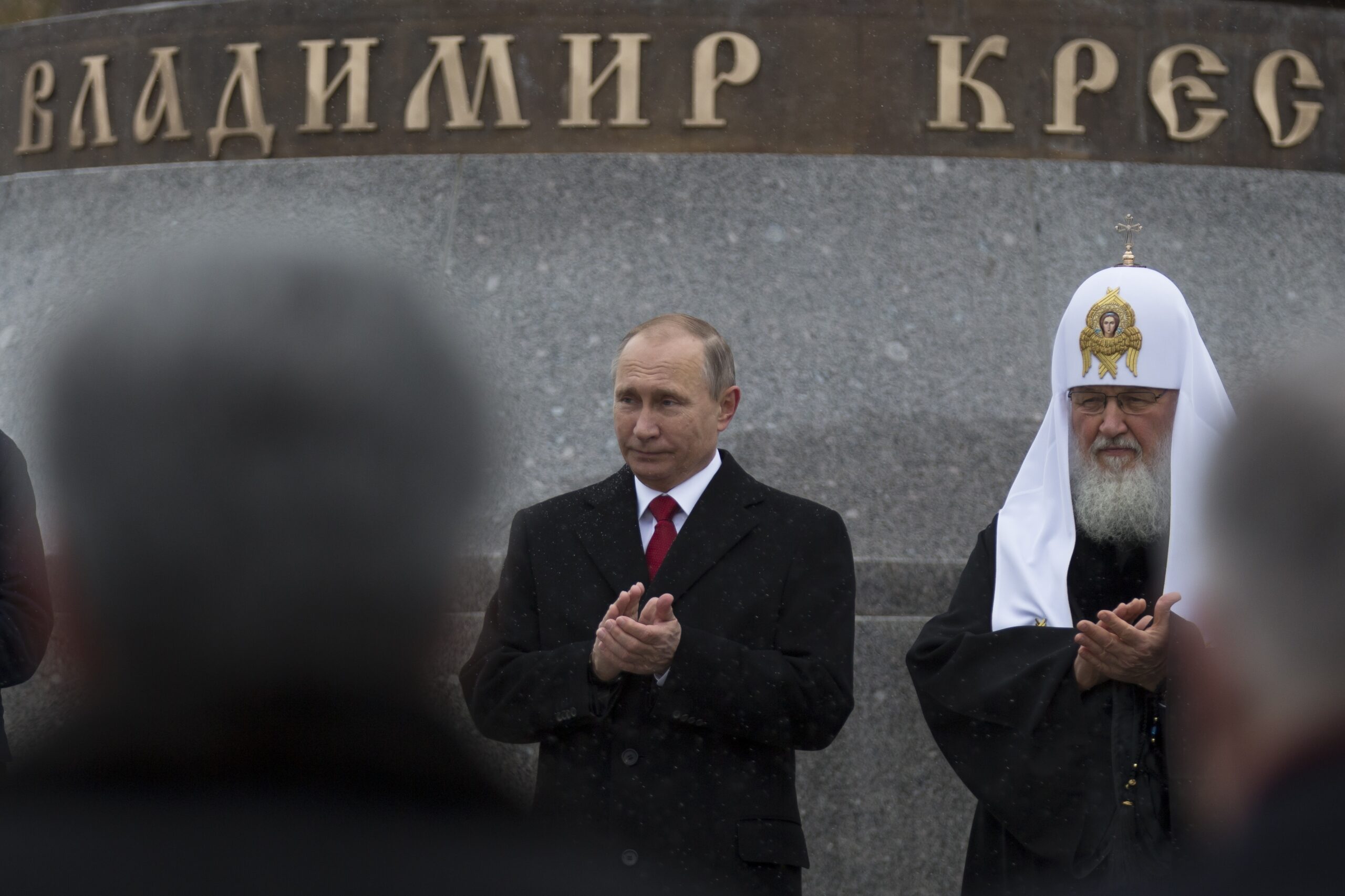 Russian President Vladimir Putin, center, and Russian Orthodox Patriarch Kirill applaud during the unveiling ceremony of a monument to Vladimir the Great on the National Unity Day outside the Kremlin in Moscow, Russia, Friday, Nov. 4, 2016. President Vladimir Putin has led ceremonies launching a large statue outside the Kremlin to a 10th-century prince of Kiev who is credited with making Orthodox Christianity the official faith of Russia, Ukraine and Belarus. (AP Photo/Alexander Zemlianichenko)