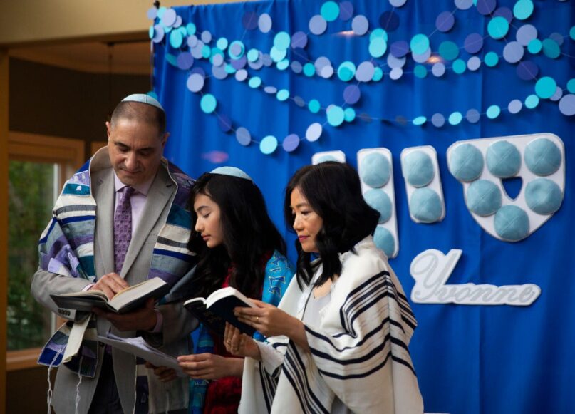 Tsvi Reiter, Yvonne Reiter and Hei Le participate in Yvonne's bat mitzvah ceremony, which was  performed over Zoom due to the COVID-19 pandemic. (Lindsey Wasson/Getty Images News via Getty Images)