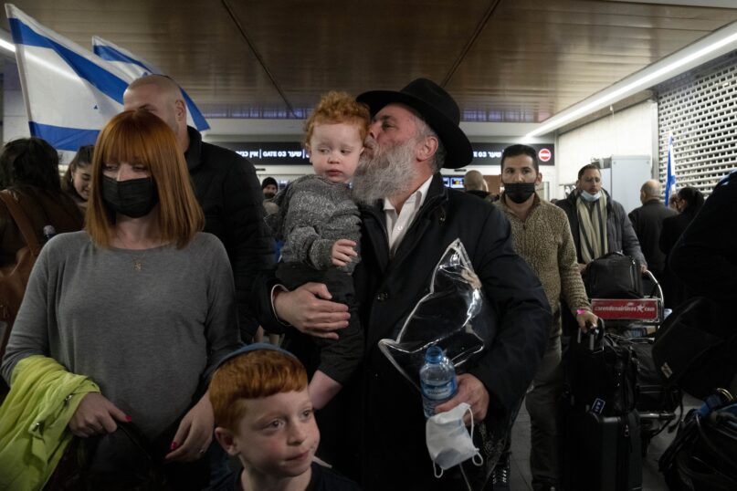 Jonathan Markovitch, the chief rabbi of Kyiv, Ukraine, arrives with his grandchild at Ben Gurion Airport in Israel. (AP Photo/Maya Alleruzzo)