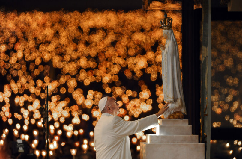 FILE - Pope Francis leads a candle light vigil prayer at the Sanctuary of Our Lady of Fatima on May 12 2017, in Fatima, Portugal. Pope Francis is presiding Friday over a special prayer for Ukraine that harks back to a century-old apocalyptic prophesy about peace and Russia that was sparked by purported visions of the Virgin Mary to three peasant children in Fatima, Portugal in 1917. Francis has invited bishops, priests and ordinary faithful around the world to join him in the consecration prayer Friday afternoon. (AP Photo/Paulo Duarte)