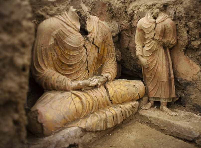 FILE - In this photograph made on Tuesday, Oct. 12, 2010 in Mes Aynak valley, south of Kabul, Afghanistan, Buddha statues are seen inside an ancient temple. The valley is the world's second-largest unexploited copper estimated to be worth nearly $1 trillion. (AP Photo/Dusan Vranic, File)