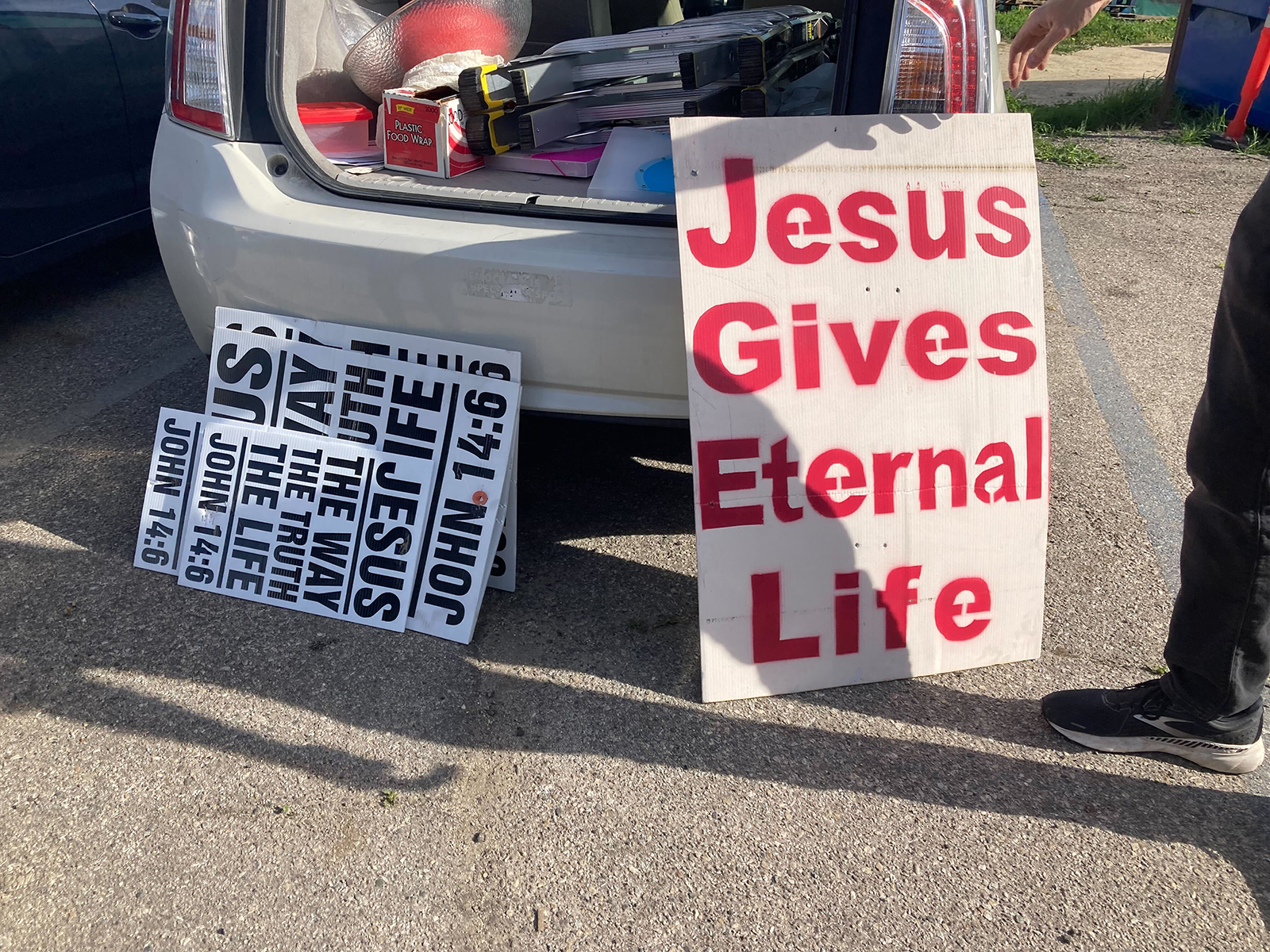 Religious materials illegally placed on public roads are removed by members of Atheists United, Saturday, Feb. 19, 2022, in Los Angeles.  RNS photo by Alejandra Molina