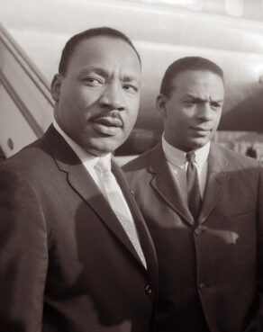 Martin Luther King, Jr. and Andrew Young arrive at Schiphol Airport in Amsterdam on August 15, 1964. King had traveled to the Netherlands to speak at the European Baptist Federation Congress at the RAI convention center on Sunday, August 16, in Amsterdam. (Alpha Historica / Alamy Stock Photo)