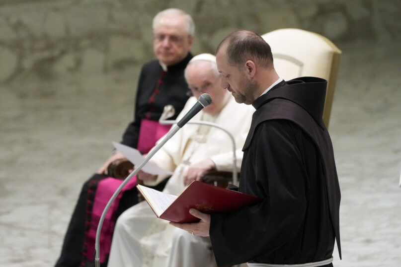 Friar Marek Viktor Gongalo, from Ukraine, reads in Polish Pope Francis' message during the weekly general audience at the Vatican, Wednesday, March 2, 2022. The Pope spoke about the elderly parents of Friar Gongalo saying his heart is with them as they hide in an underground refuge near Kyiv. Speaking at the end of the weekly audience, the Pope thanked the Polish people for opening their borders, hearts and homes to Ukrainians. (AP Photo/Gregorio Borgia)