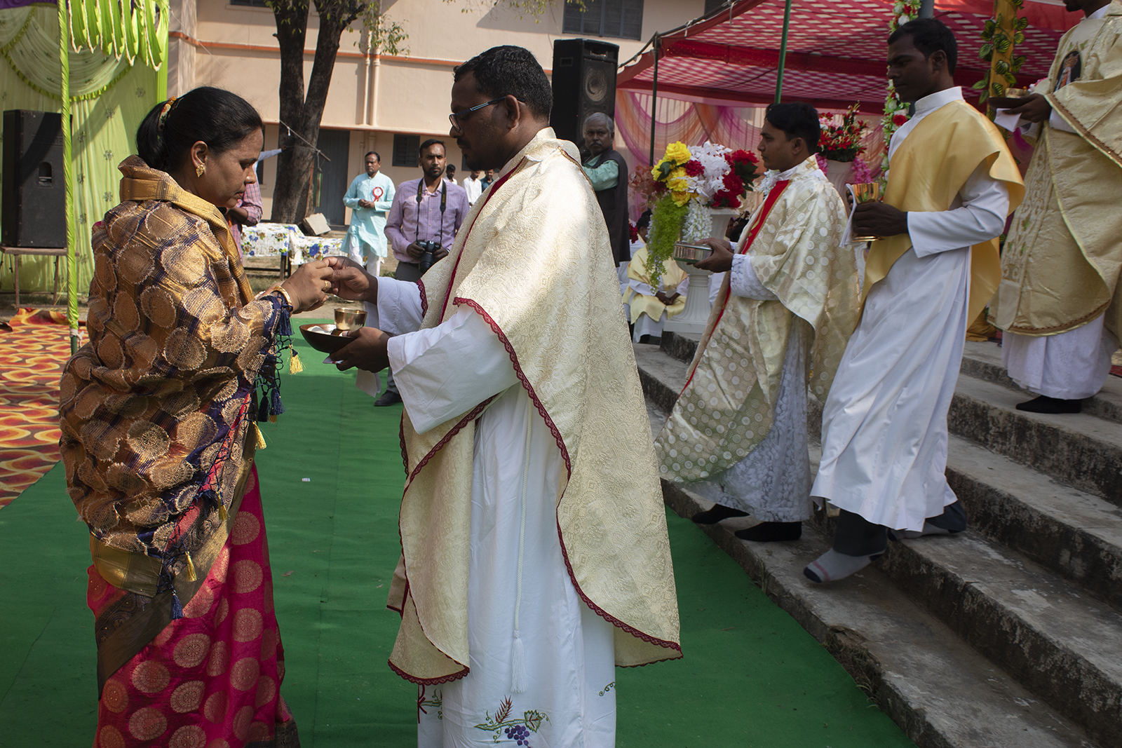 Father Vikas Nayak offers Holy Communion to his aunt following his ordination ceremony at the Church of the Ascension of the Lord in Buxar, India, in Nov. 2021. Photo by Abhijeet Nayak