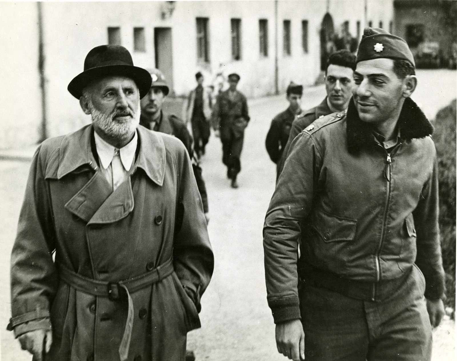 Julius Streicher, left, captured former editor of the Nazi paper 'Der Stürmer', walking with U.S. Major Henry G. Plitt in May 1945. Photo via ww2online.org