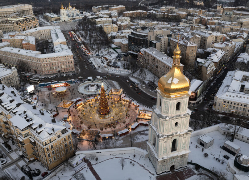 Snow covers the city center and a Christmas tree with St. Sophia Cathedral, foreground, and St. Michael Cathedral, background, in Kyiv, Ukraine, Dec. 21, 2021. (AP Photo/Efrem Lukatsky, File)