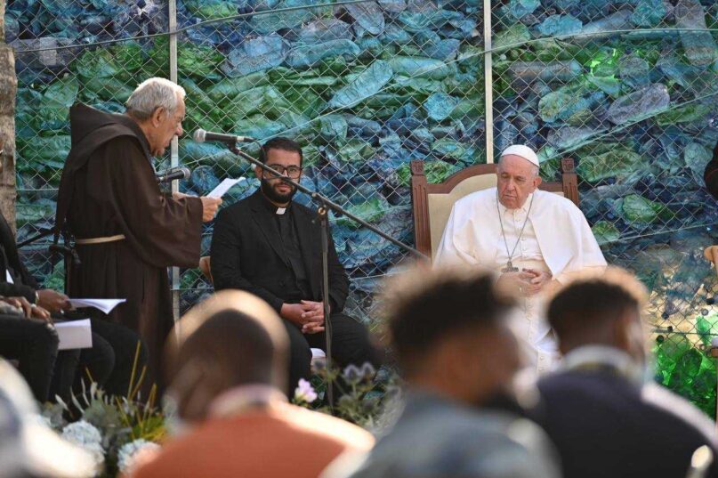 Pope Francis and an unidentified priest listen to remarks by the Rev. Dionysius Mintoff, founder of the Pope John XXIII Peace Lab in Hal Far, Malta, Sunday, April 3, 2022. Vatican pool photo