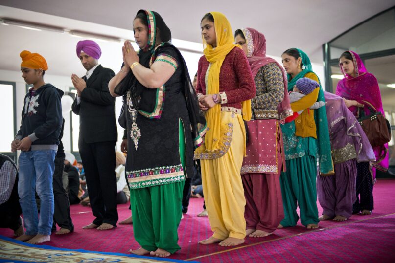 Sikh men and women during a prayer service during the Baisakhi festival. (Giovanni Mereghetti/Education Images/Universal Images Group via Getty Images)