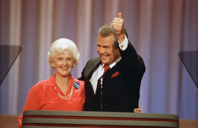 FILE - Former Republican presidential hopeful Pat Robertson gives a thumbs-up as he and his wife, Dee Dee, acknowledge applause at the Republican National Convention in New Orleans, Tuesday, August 17, 1988. Adelia “Dede” Robertson, the wife of religious broadcaster Pat Robertson as well as an author and founding board member of the Christian Broadcasting Network, died Tuesday, April 19, 2022, at her home in Virginia Beach. She was 94. (AP Photo/Ron Edmonds, File)