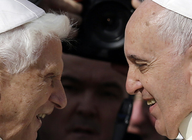 FILE - Pope Francis, right, greets Pope Emeritus Benedict XVI prior to the start of a meeting with elderly faithful in St. Peter's Square at the Vatican, on Sept. 28, 2014. Emeritus Pope Benedict XVI turned 95 this past weekend, a significant milestone on its own but even more given he has now been a retired pope longer than he was a reigning one.  To mark the occasion, a new book published Thursday, April 21, 2022 sets out to examine the current state of Vatican affairs not so much through the lens of Pope Francis’ nine-year papacy, but via Benedict’s nine-year retirement. (AP Photo/Gregorio Borgia, File)