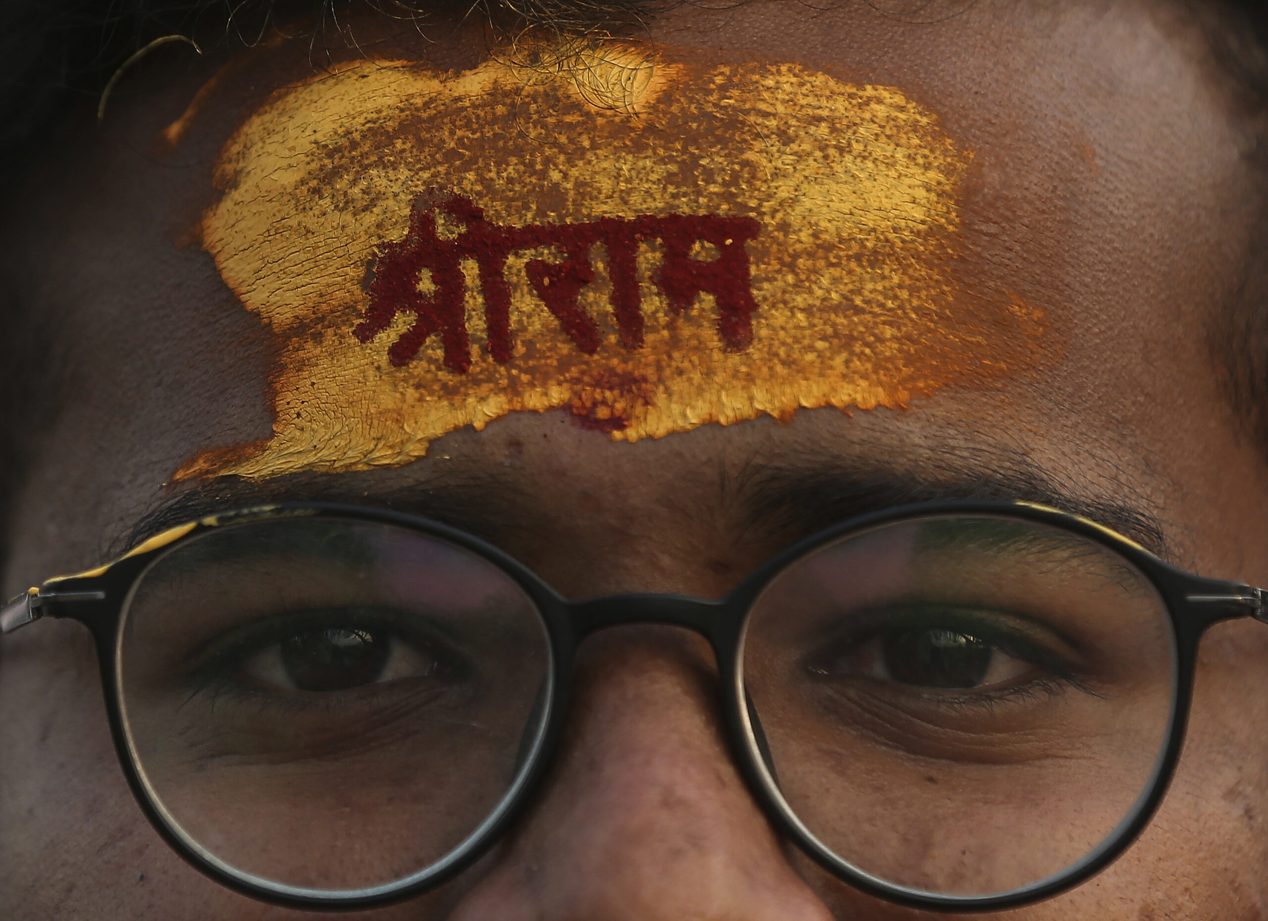 A devotee has the name of Hindu god Rama written on his forehead during a religious procession to celebrate Ram Navami, a Hindu festival marking the birth anniversary of Lord Ram, in Hyderabad, India, Sunday, April 10, 2022. India’s hardline Hindu nationalists have long espoused an anti-Muslim stance, but attacks against the minority community have recently occurred more frequently. In Madhya Pradesh state’s Khargone city, the festival turned violent after Hindu mobs brandishing swords and sticks marched past Muslim neighborhoods and mosques. (AP Photo/Mahesh Kumar A., File)