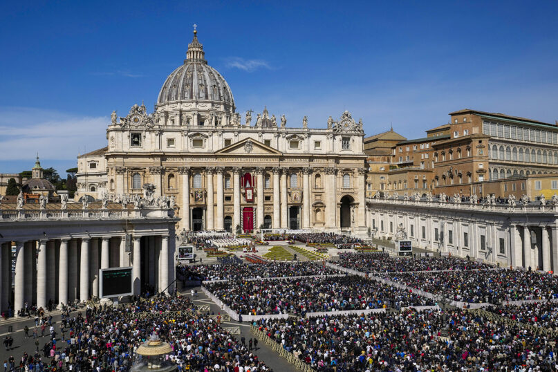 Faithful gather to attend the Catholic Easter Sunday Mass led by Pope Francis in St. Peter's Square at the Vatican, April 17, 2022. For many Christians, the weekend marked the first time in three years that they gathered in person to celebrate Easter Sunday. (AP Photo/Alessandra Tarantino)