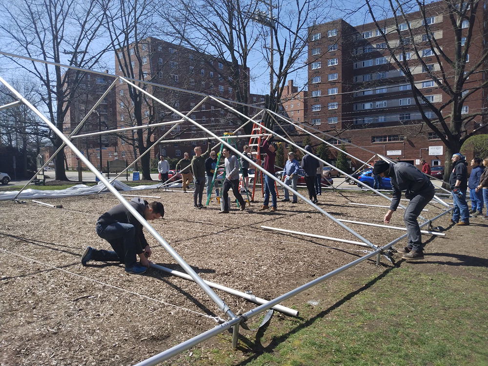People work to construct a large outdoor tent at Church of the Ascension in Pittsburgh, Pennsylvania, April 2, 2022. Photo courtesy of Church of the Ascension