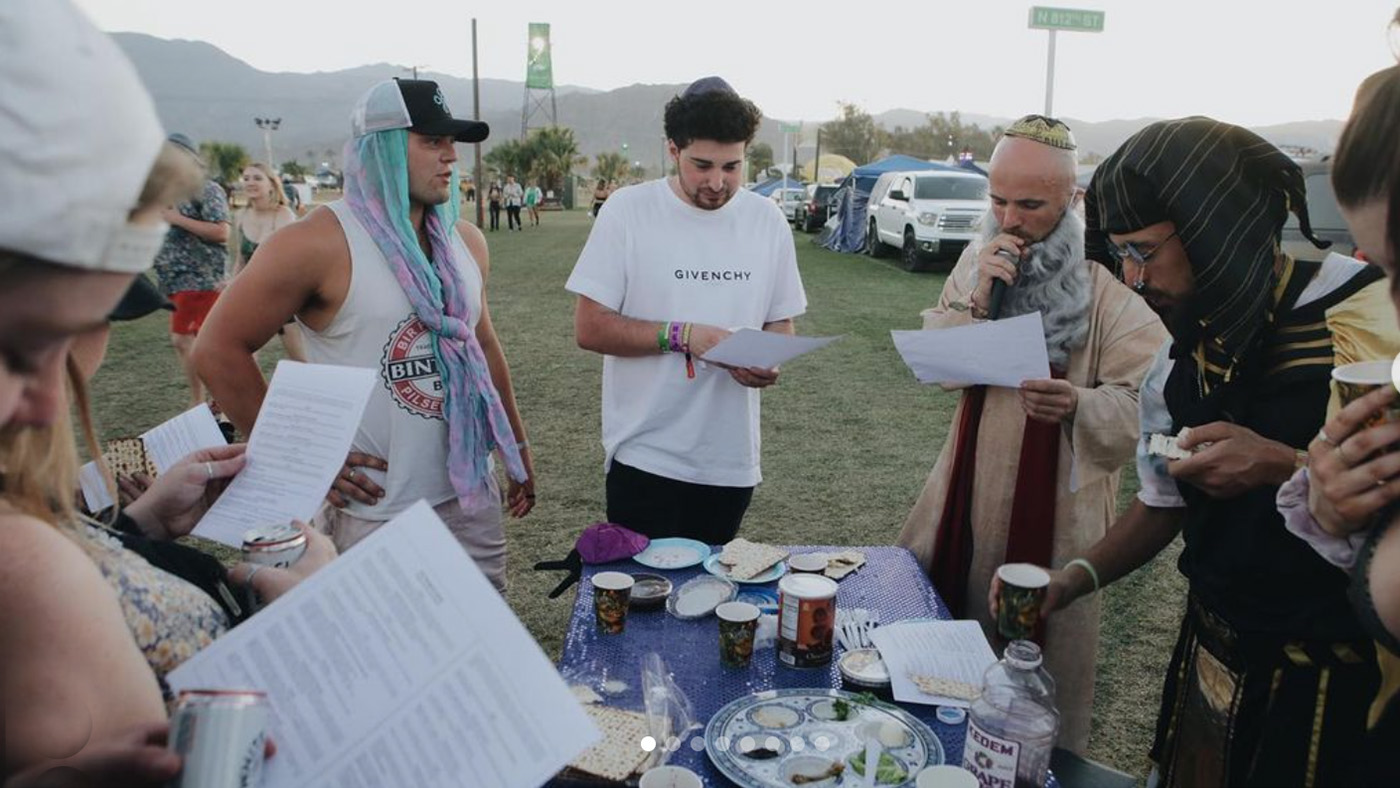 Rapper Kosha Dillz, center right, dressed as Moses, leads mini-Seders outside the Shabbat Tent at the Coachella music festival in Indio, California. Dillz refers to the event as Matzahchella. Photo via Instagram/@chrism_arts