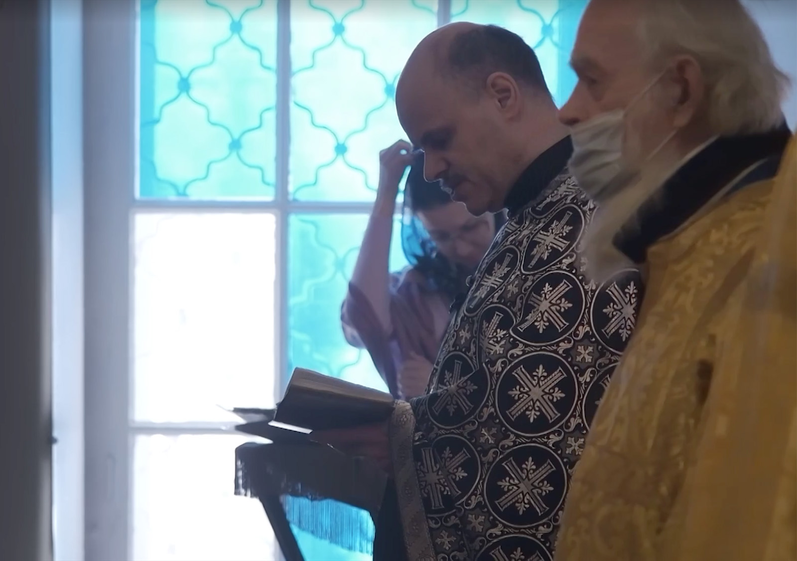The Rev. John Burdin, center, leads a service at Resurrection of Christ Orthodox Church in the Russian village of Nikolskoye. Video screen grab via CurrentTime.tv