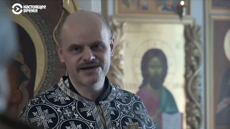 The Rev. John Burdin leads a service at Resurrection of Christ Orthodox Church in the Russian village of Nikolskoye. Video screen grab via CurrentTime.tv