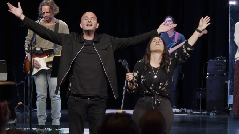 Pastors Alan and Kathryn Scott sing and pray during a service at Vineyard Anaheim, which is being renamed the Dwelling Place, on April 24, 2022. Video screen grab