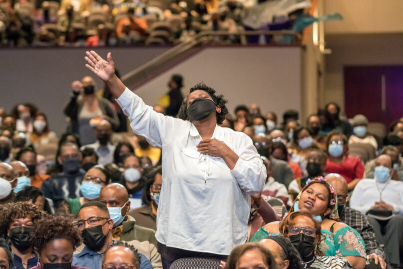 A woman stands during worship at First Baptist Church of Glenarden on Sunday, April 3, 2022, in Upper Marlboro, Maryland. Photo courtesy of FBCG