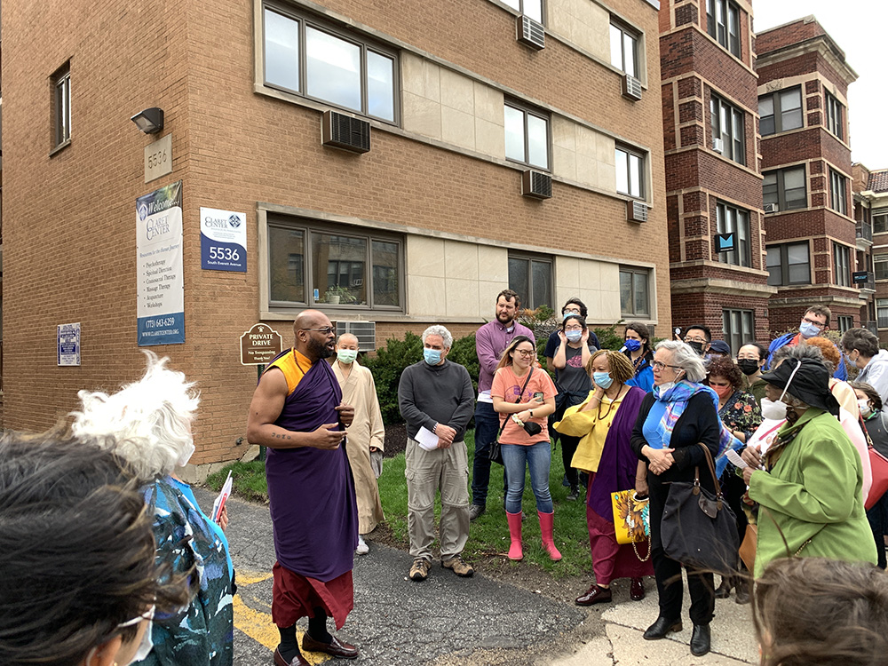Heiwa no Bushi, center left, teacher of BodhiChristo of North Carolina, speaks to the Chicago Interfaith Trolley Tour during a stop at the Claret Center, Sunday, April 24, 2022, in Chicago.  RNS photo by Bob Smietana