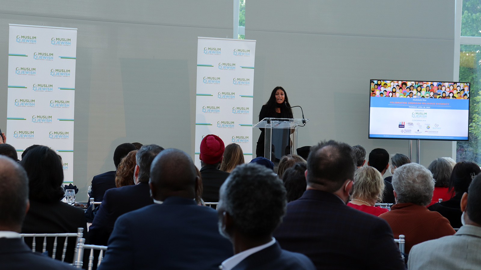 Nina Fernando, executive director of Shoulder to Shoulder, sings during a multifaith iftar at the U.S. Institute of Peace headquarters in Washington, D.C., Thursday, April 28, 2022. RNS photo by Adelle M. Banks